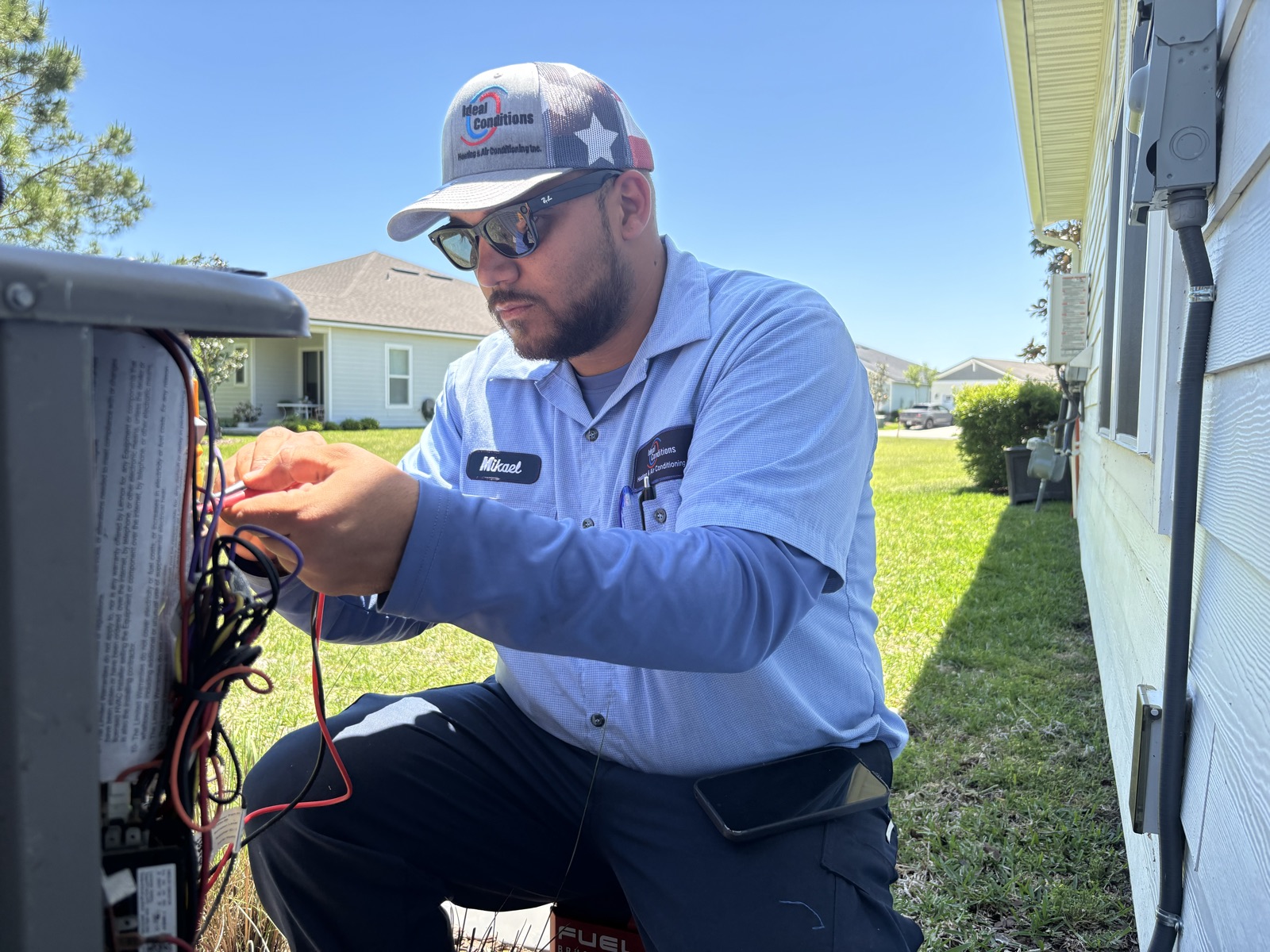Ideal Conditions technician using diagnostic leads during an AC maintenance call in Mandarin, Jacksonville