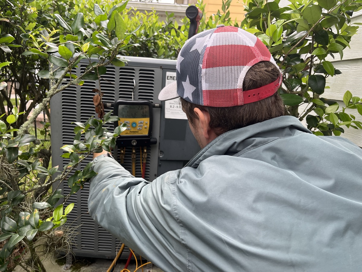 Ideal Conditions technician repairing a residential air conditioner in Jacksonville