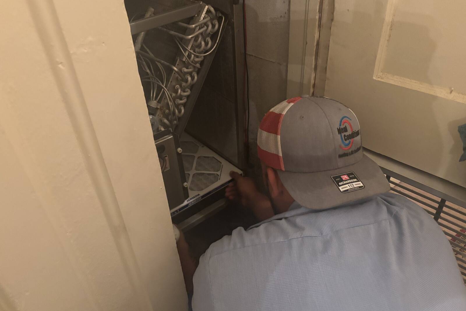 Pleated MERV-rated air filter being replaced in a Jacksonville home HVAC system
