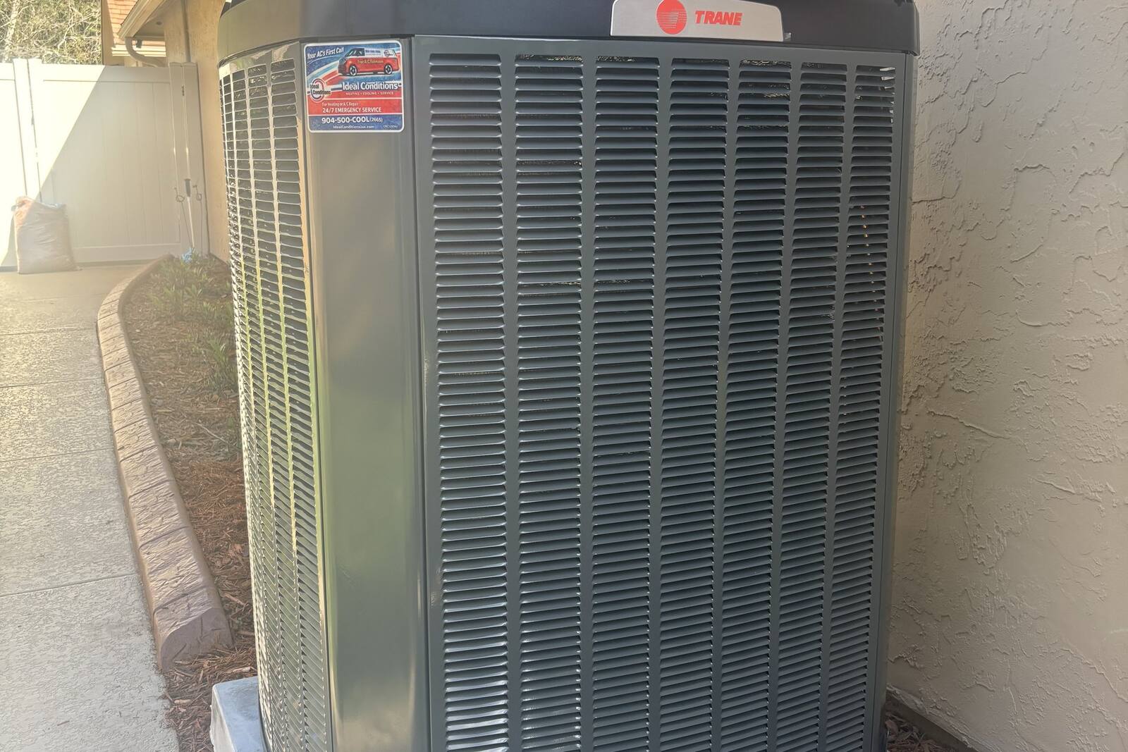 Trane AC condenser installed beside a Jacksonville home