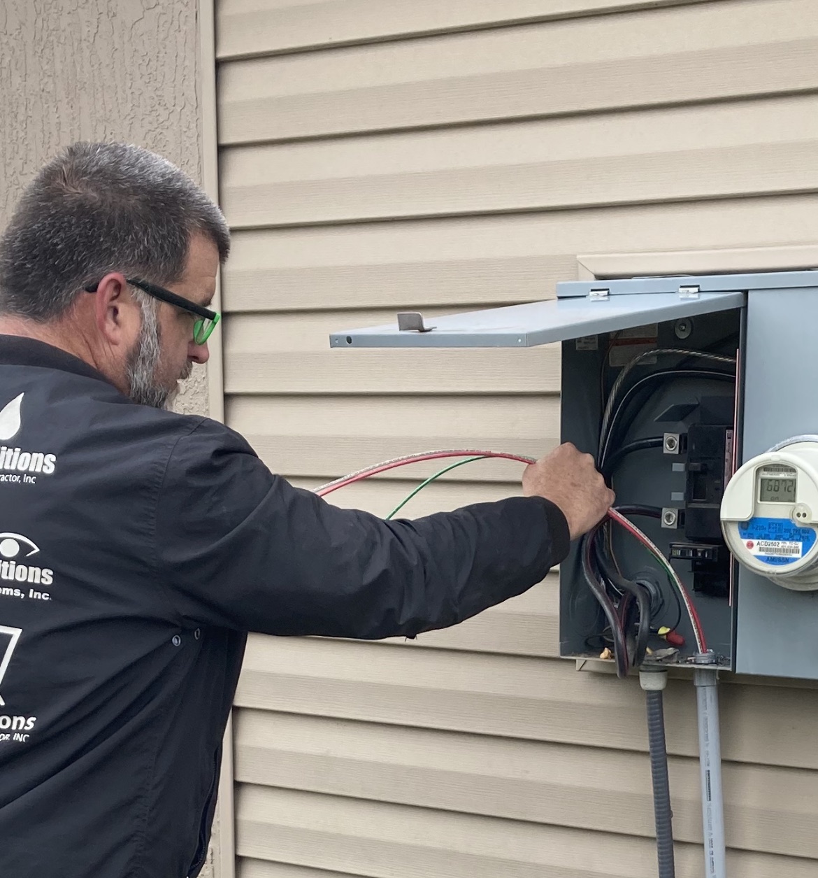Licensed Ideal Conditions electrician working on a Jacksonville home service panel