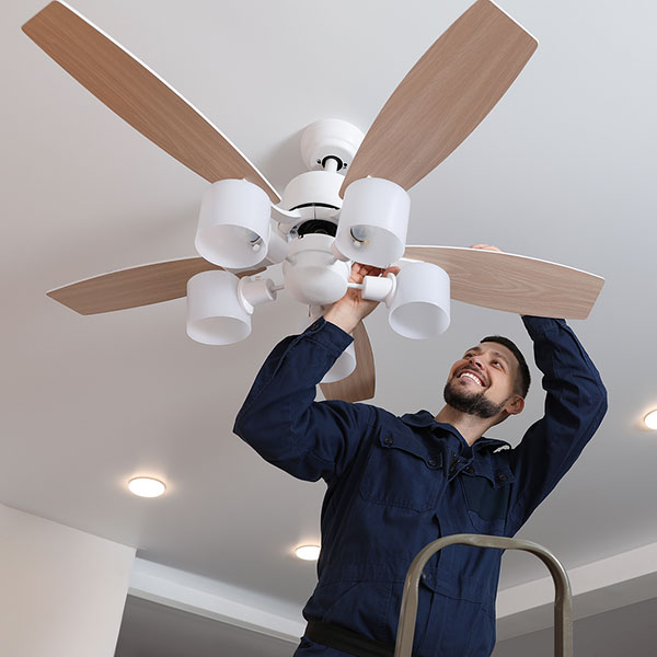 man repairing a ceiling fan